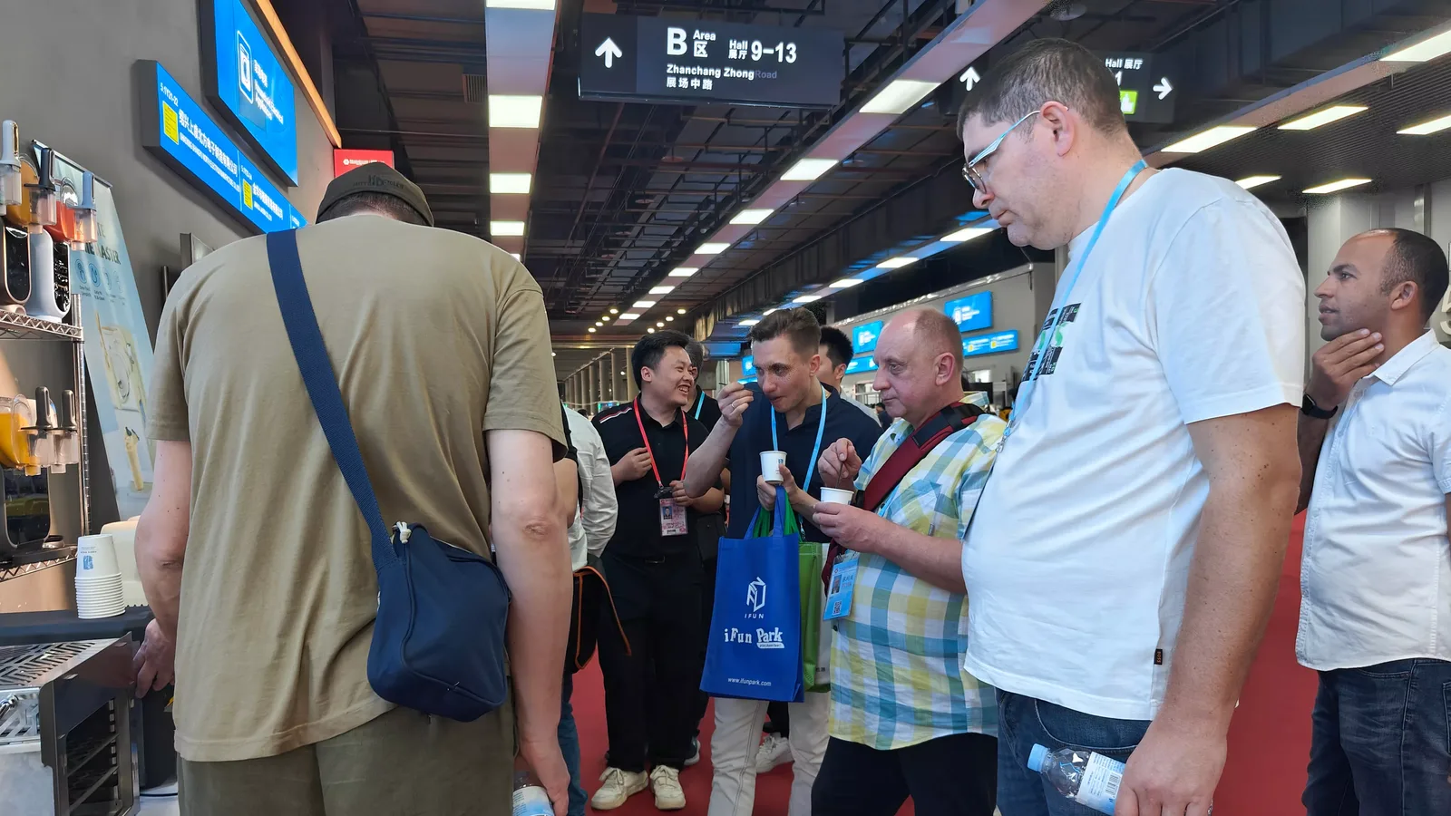 Buyers at a Gulfstone stand in a trade exhibition hall, under the hall directory signage