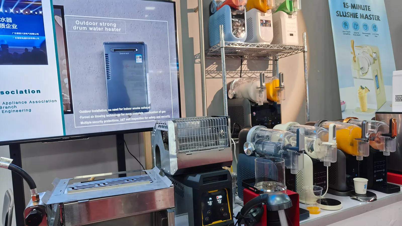 A Gulfstone display screen and product shelf at the company stand, with a water heater on the bench beneath