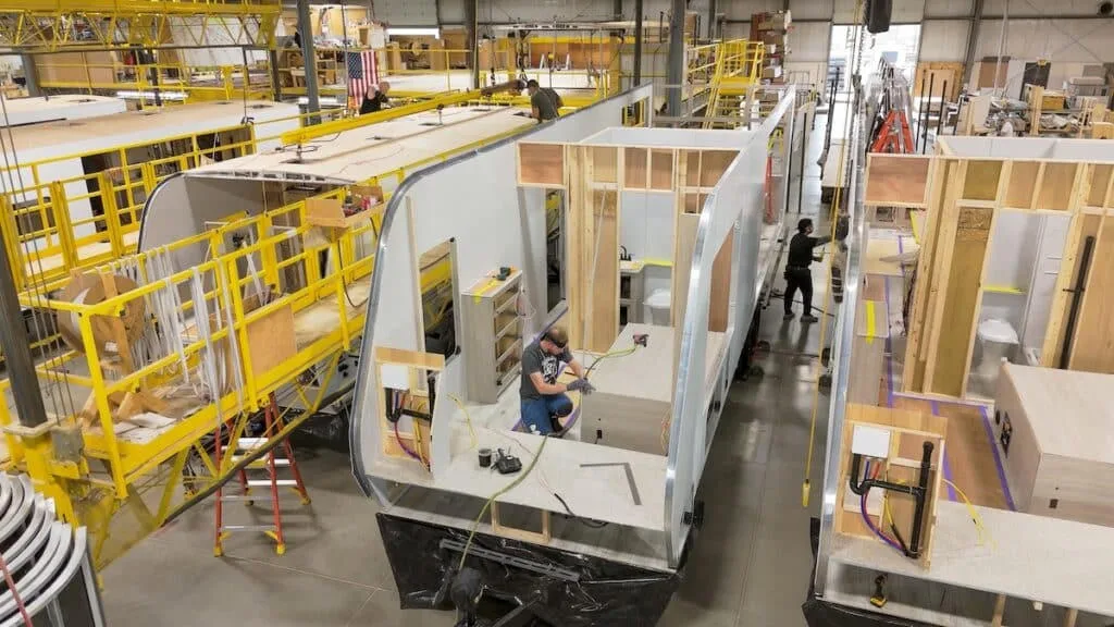 An RV assembly line with interior cutouts and framing laid out, the floor-plan geometry that fixes appliance sourcing decisions