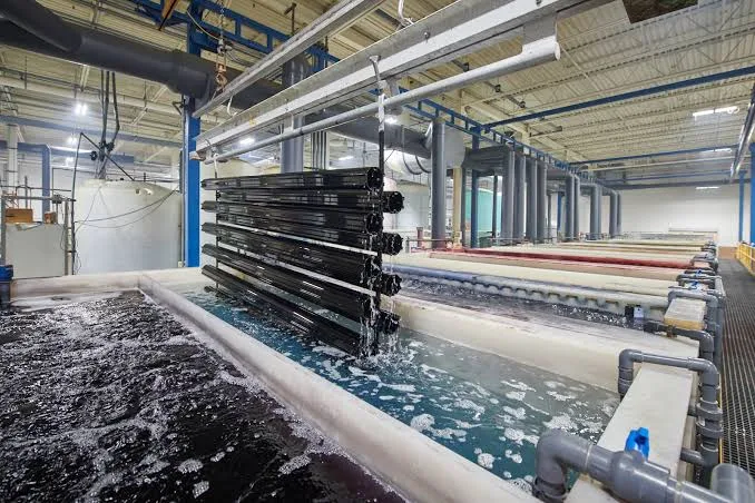 Parts suspended over an electroplating line in a factory, an outside process that must be declared, audited and traceable