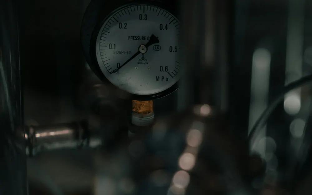 Close-up of a pressure gauge mounted on industrial equipment