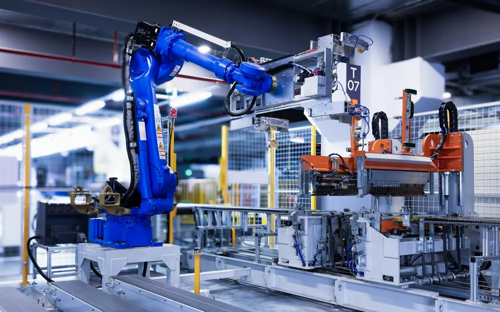 A robotic arm working at a station on a production line