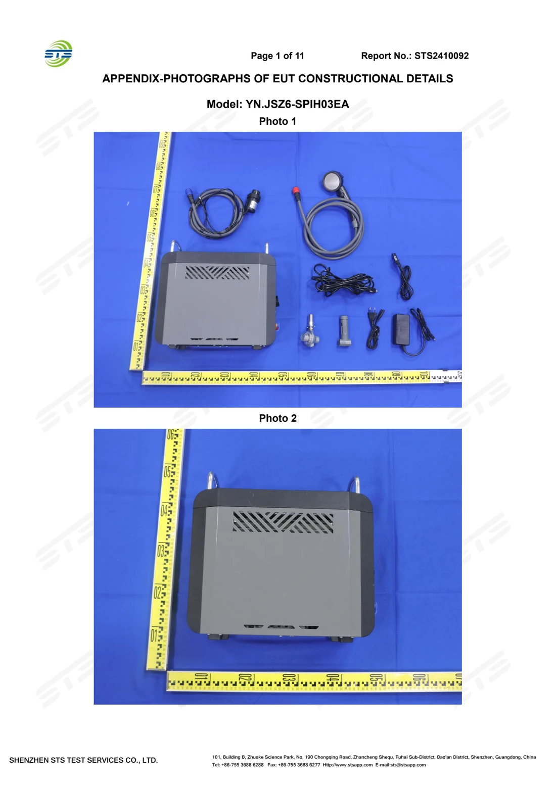 Page one of the laboratory photographic record showing the tested unit, its leads and its accessories laid out against a rule