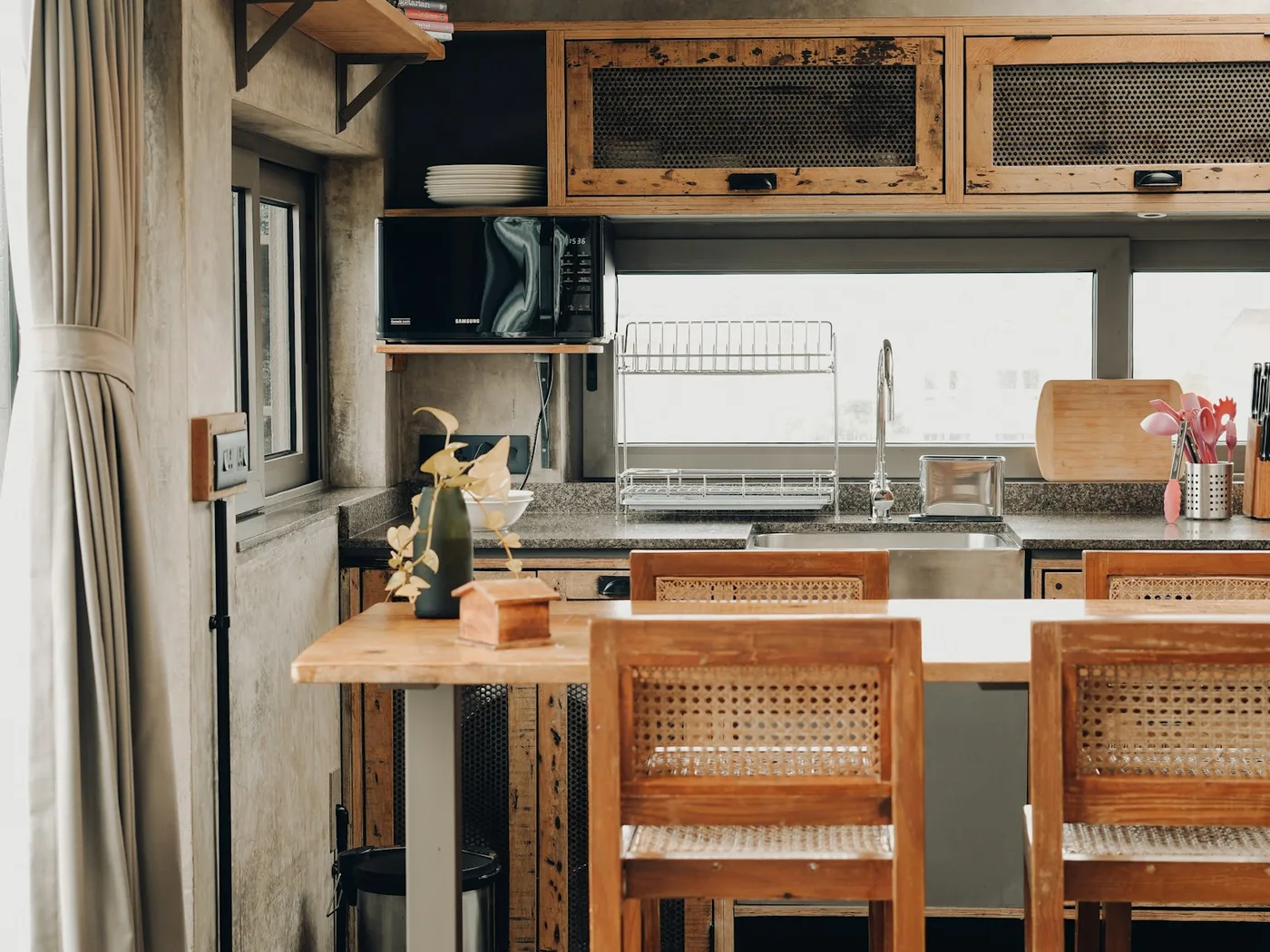 The sleeping and seating end of a camper interior with lockers below the berth