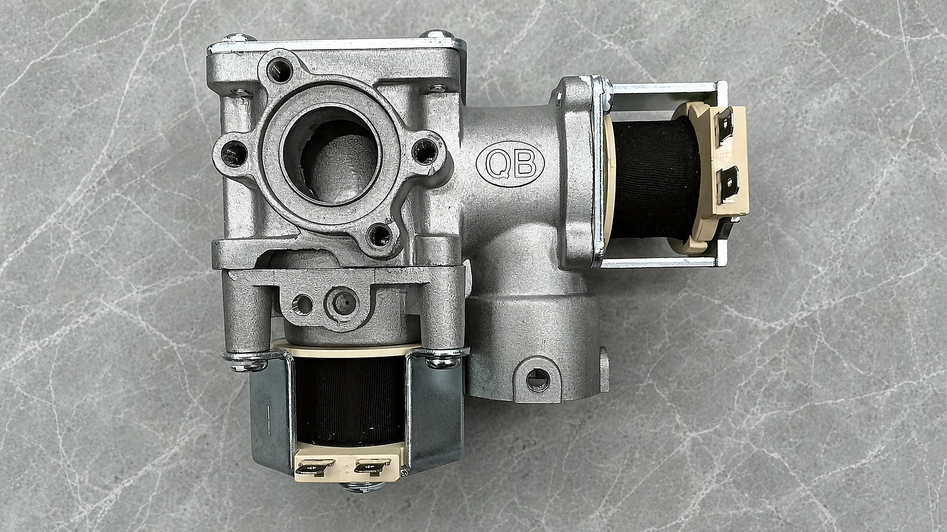 The Gulfstone RV water heater proportional gas valve: a die-cast body with two solenoid coils and a modulating section, stamped QB
